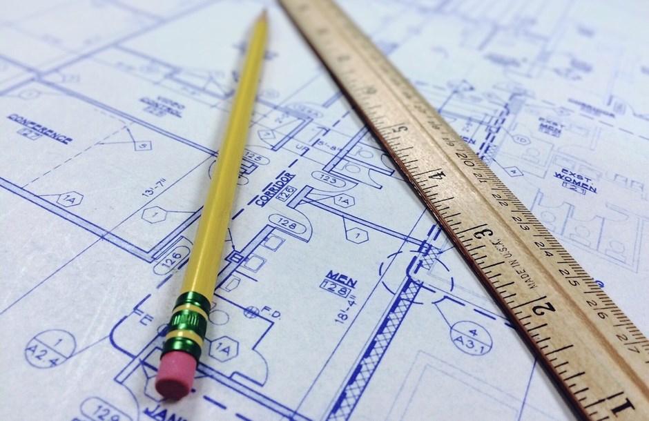 A pencil and a ruler lying on an architectural plan